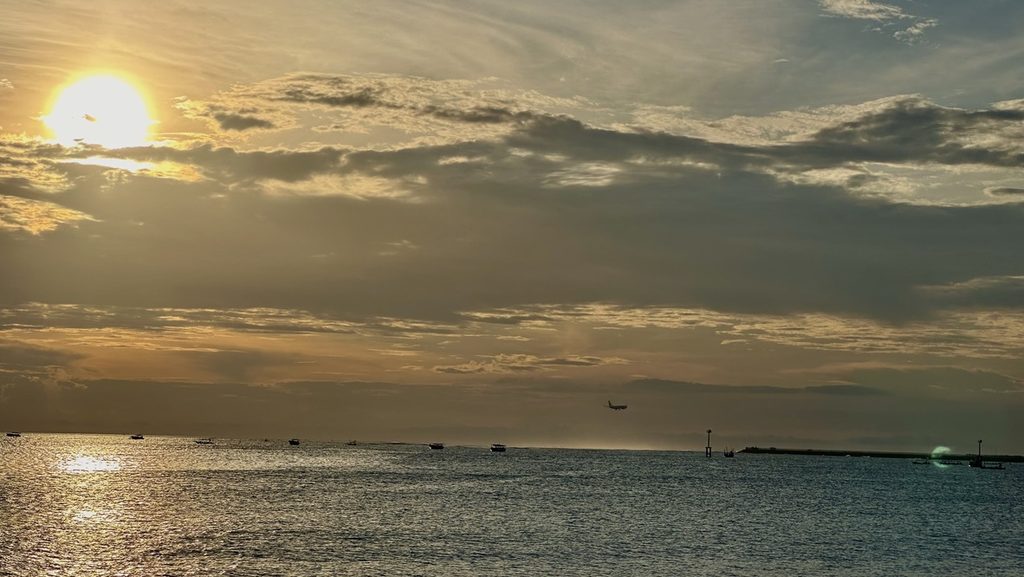 水平線へ沈むジンバランビーチの夕日